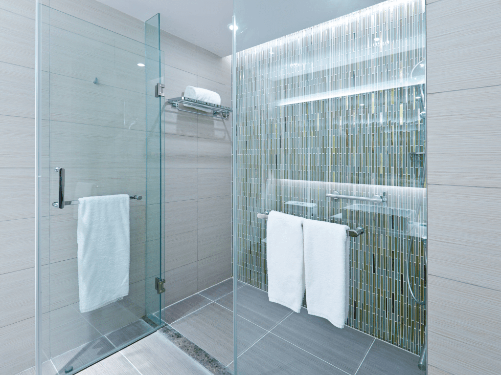 Newly remodeled bathroom in Plymouth PA featuring a walk-in shower and elegant tiles.