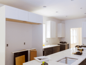 Modern-industrial kitchen style with exposed brick walls, concrete countertops, and metal pendant lights in a Scranton loft