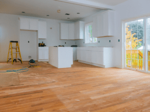 Spacious kitchen with white shaker cabinets, marble countertops, and a central island with bar seating in a NEPA home by RNS Construction