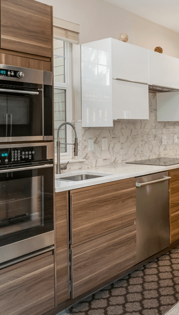 Modern, spacious kitchen with gleaming quartz countertops, custom shaker cabinets, and state-of-the-art stainless steel appliances designed by RNS Construction's expert team.