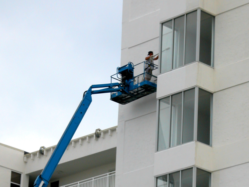 Exterior commercial painting in progress by RNS Construction, highlighting their expertise and efficiency on a large building facade in Wilkes-Barre